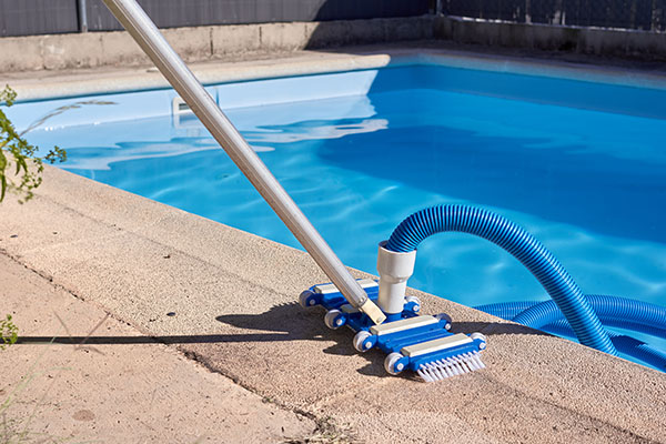 Private pool with a pool cleaner on the curb